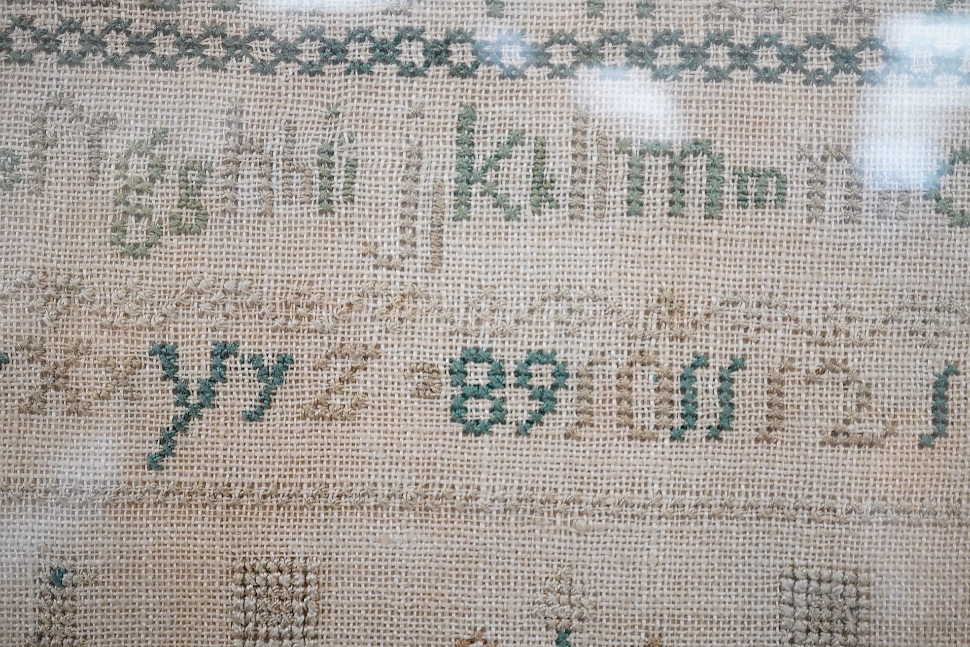 An early 19th century sampler dated 07, by Sarah Baker, ‘Henry IV’s Soliloquy of Sleep’, together with a later smaller alphabet and spot motif sampler by Elizabeth Fleet aged 8, dated 1838, both framed